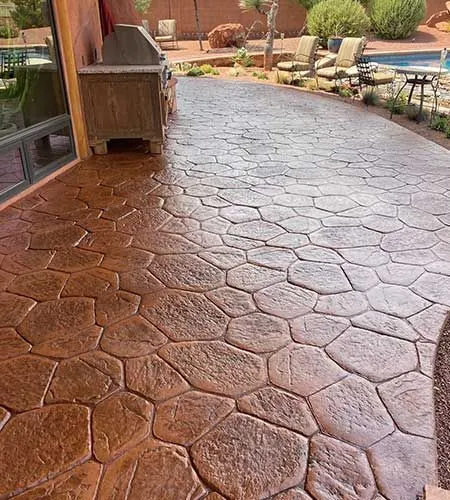 Brown patterned concrete patio with outdoor kitchen.