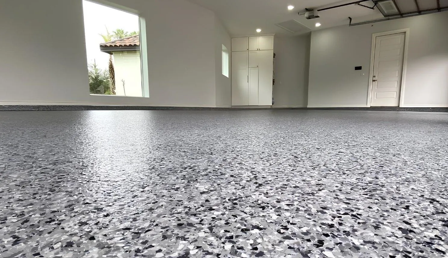 Grey and white flake epoxy garage floor installed by our crew