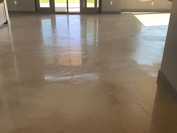 Polished concrete floor reflecting sunlight, interior view.